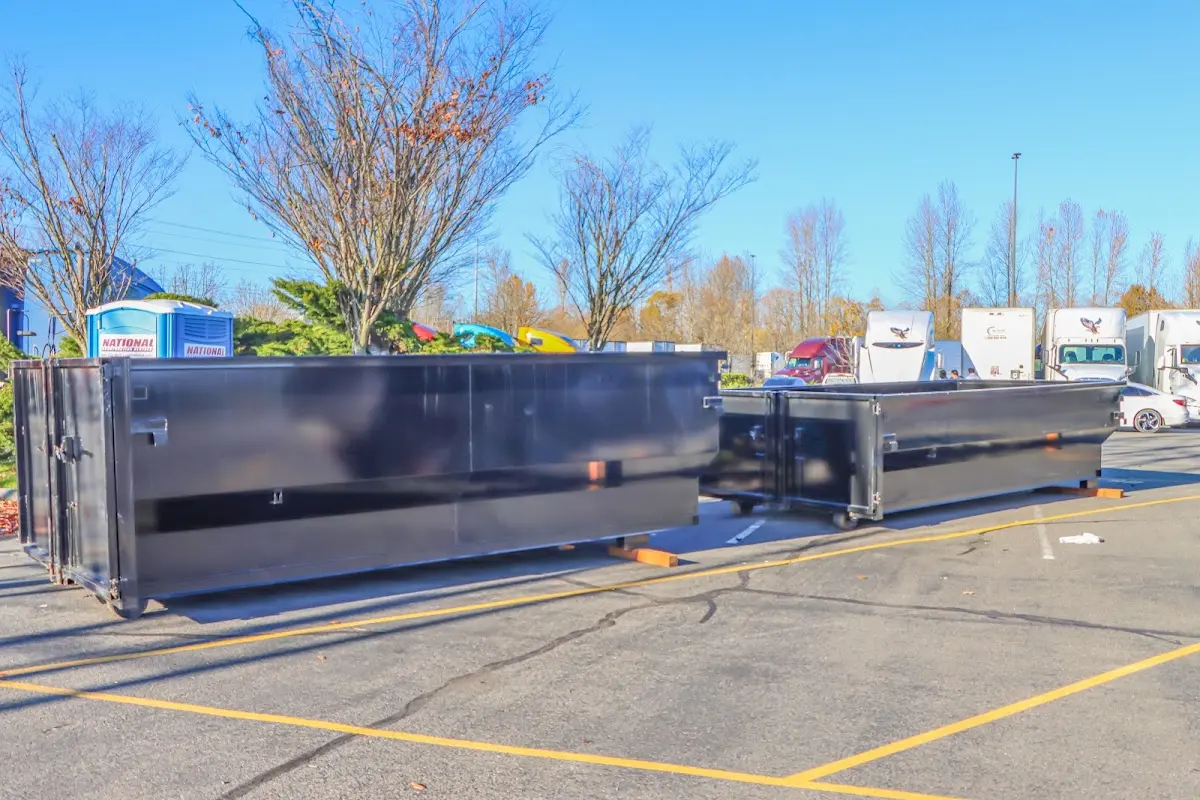 Professional dumpster rental service with roll-off container on residential driveway in Gastonia